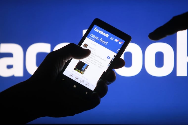 A user shows the Facebook application on his smartphone in the central Bosnian town of Zenica.