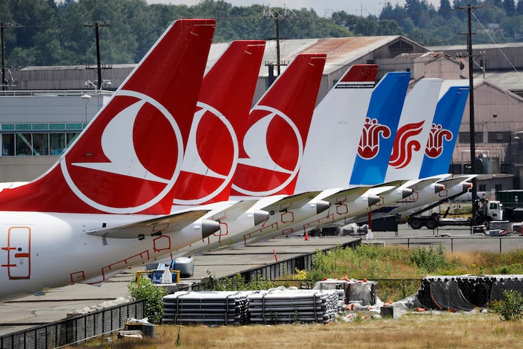 The tails of several of the dozens of grounded Boeing 737 MAX airplanes line the edge of a parking area adjacent to Boeing Field Thursday, June 27, 2019, in Seattle. A new software problem has been found in the troubled Boeing 737 Max that could push the plane's nose down automatically, and fixing the flaw is almost certain to further delay the plane's return to flying after two deadly crashes. Boeing said Wednesday, June 26, 2019, that the FAA "identified an additional requirement" for software changes that the aircraft manufacturer has been working on for eight months, since shortly after the first crash. (AP Photo/Elaine Thompson)