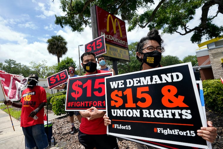 Workers and family members take part in a 15-city walkout to demand $15hr wages Wednesday, May 19, 2021, in front of a McDonald's restaurant in Sanford, Fla. From minimum wage increases to animal protection to police accountability to both cutting and increasing taxes a series of new laws are taking effect across the country on Saturday, Jan. 1, 2022.