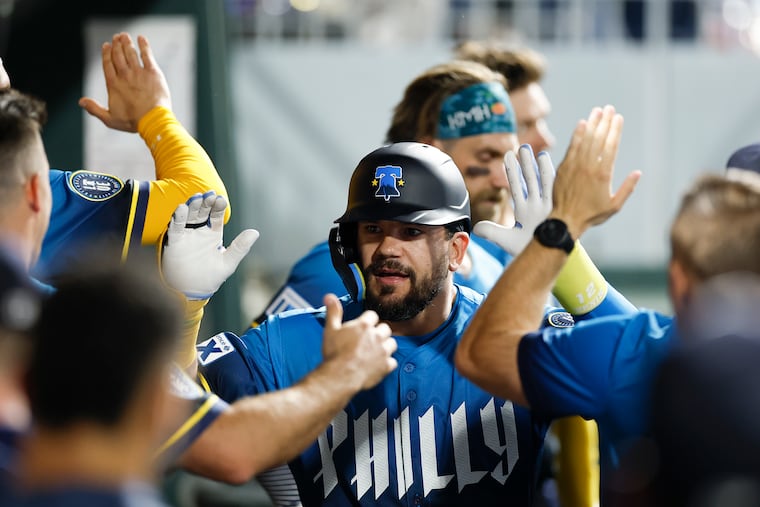 Phillies Kyle Schwarber celebrates his seventh-inning solo home run with teammates against the Arizona Diamondbacks on Friday.