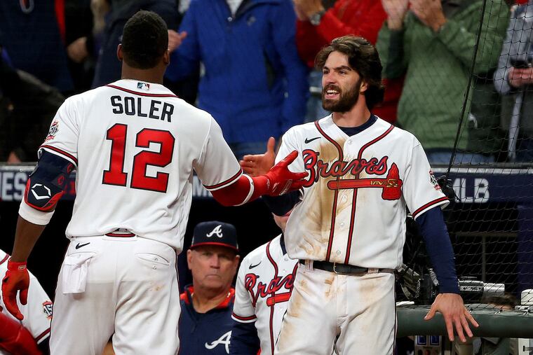 The Atlanta Braves' Jorge Soler is congratulated by Dansby Swanson after they hit back-to-back solo home runs during the seventh inning to wrest the lead away from the Houston Astros in Game 4 of the World Series at Truist Park on Saturday, Oct. 30, 2021, in Atlanta.