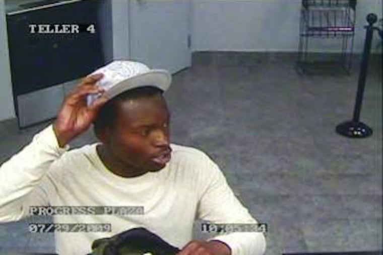 This image from a bank security camera shows the individual wanted in connection with a robbery yesterday morning at the United Bank of Philadelphia Progress Plaza branch at 1501 N. Broad St.