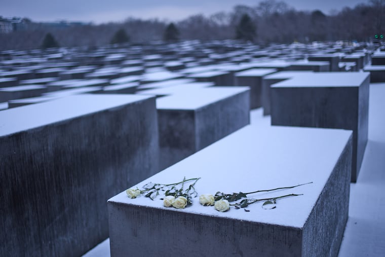 White roses placed on a concrete slab of the Holocaust memorial to mark the International Holocaust Memorial Day in Berlin, Germany, Tuesday, Jan. 27, 2026.