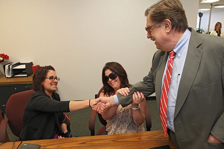 Tamara Davis, left, and Nicola Cucinotta, center, say thank you to D. Bruce Hanes, right, the Recorder of Wills for Montgomery County, for opening up marriage licenses to same-sex couples. (MICHAEL BRYANT / Staff Photographer)