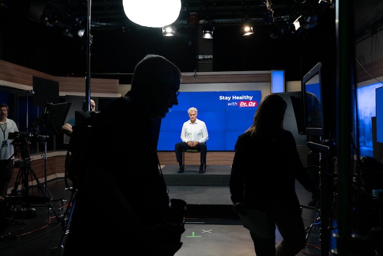 Mehmet Oz, administrator for the Centers for Medicare & Medicaid Services, demonstrates yoga stretches for a video for Medicare enrollees in a studio at the CMS headquarters. MUST CREDIT: Maxine Wallace/The Washington Post