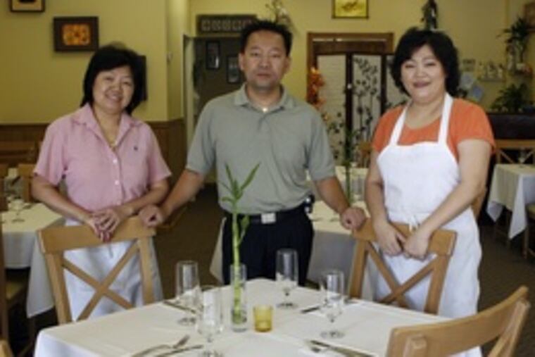 Co-owners Quan Luu (left), Peter Tat and Fong To at their new restaurant, Taste of Saigon, in the New Market shopping center in Sewell. The restaurant specializes in Vietnamese favorites but also offers some Thai dishes.