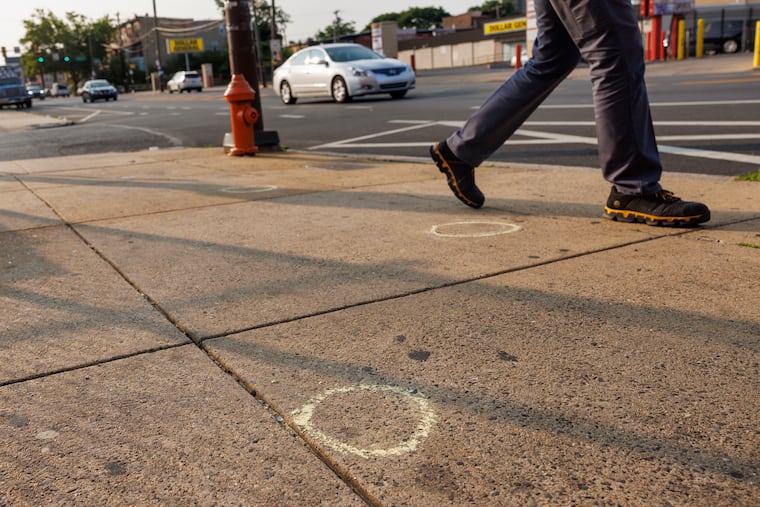 Philadelphia police evidence chalk circles along 1300 block of W. Lehigh Avenue at North Park in North Philadelphia where an Uber driver was struck by a bullet in the head shortly before midnight Wednesday. The vehicle then stopped after hitting a utility pole just past N. Broad Street. Photograph taken on Thursday morning June 15, 2023.