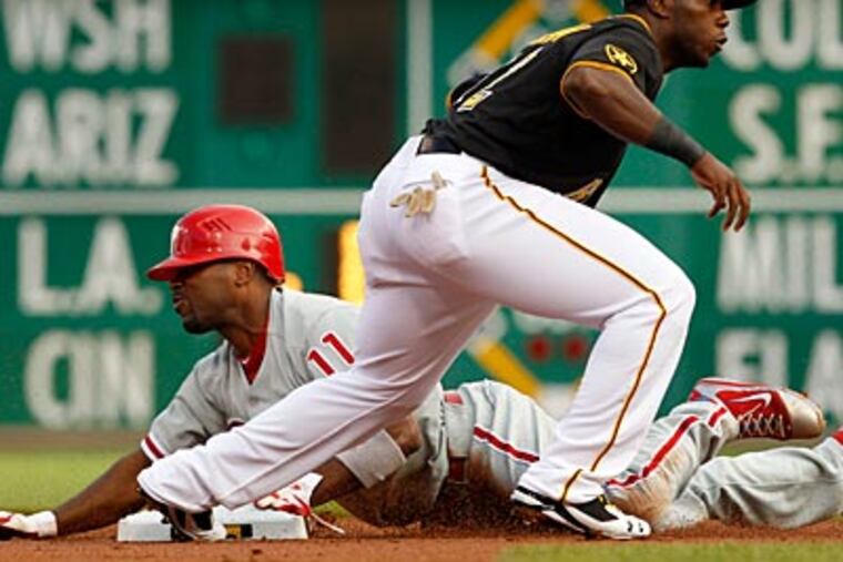 The Pirates' Josh Harrison puts the late tag on Jimmy Rollins during the first inning on Friday. (Gene J. Puskar/AP Photo)