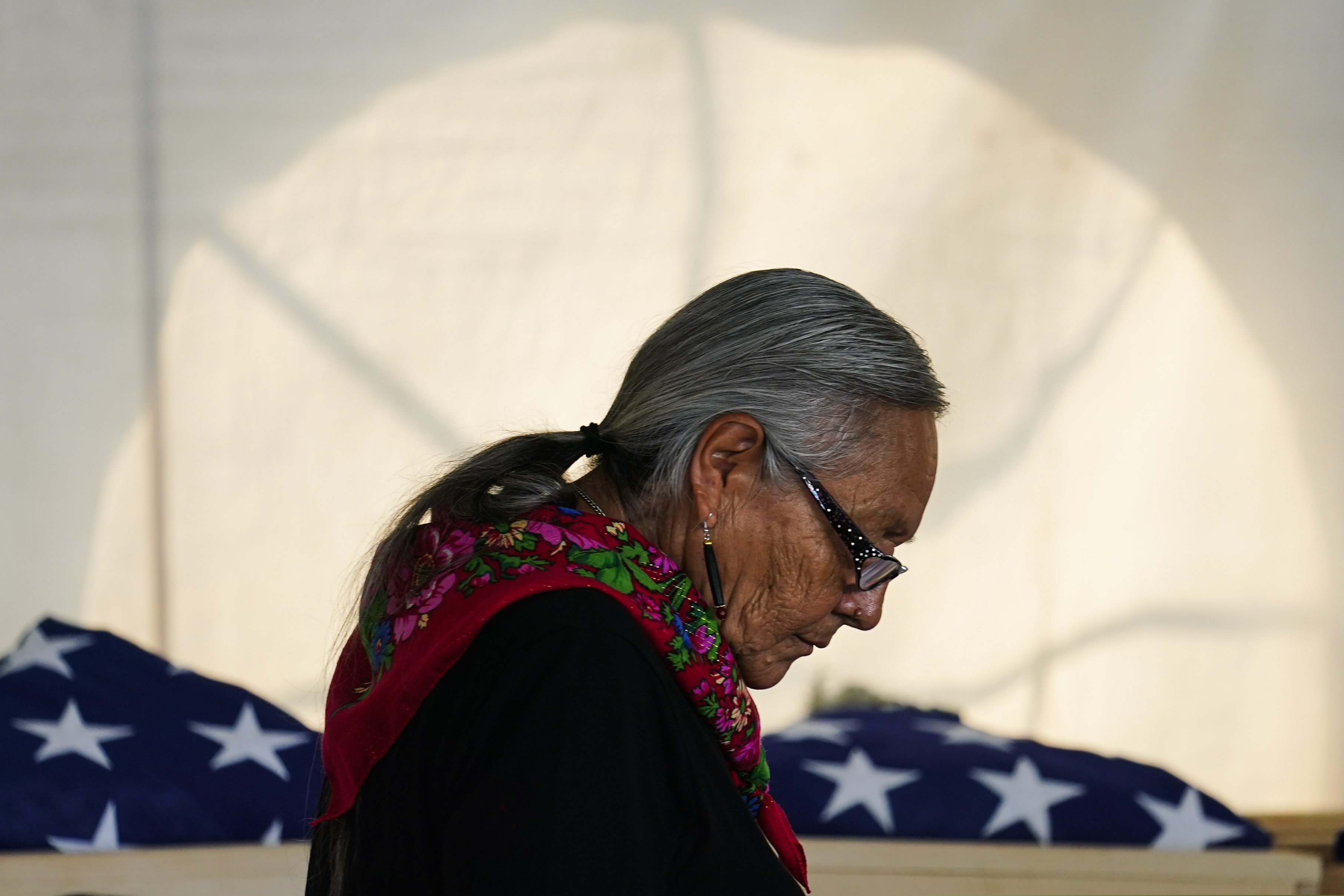 Ione Quigley, the Rosebud Sioux's historic preservation officer, returns to her seat after speaking during a ceremony at the U.S. Army's Carlisle Barracks, in Carlisle, Pa., Wednesday, July 14, 2021. The disinterred remains of nine Native American children who died more than a century ago while attending a government-run school in Pennsylvania were headed home to Rosebud Sioux tribal lands in South Dakota on Wednesday after a ceremony returning them to relatives.