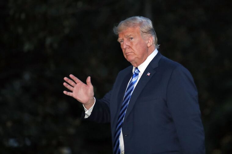 President Trump waves as he walks on the South Lawn of the White House after stepping off Marine One, Monday, Aug. 13, 2018, in Washington.