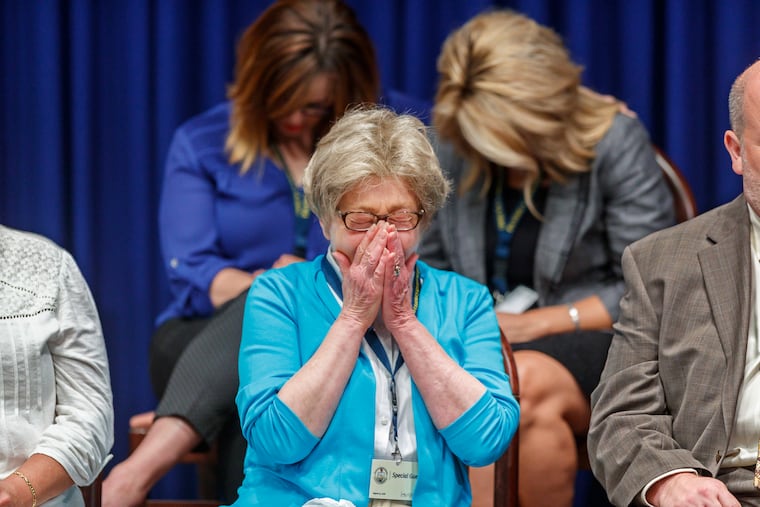 Juliann Bortz, one of the 16 sexual abuse victims seated on stage with Pennsylvania Attorney General Josh Shapiro, breaks down in tears as Shapiro speaks of the details of one priest's abuse of a youth parishner during his press conference on the findings of the Grand Jury Report on Child Sexual Abuse in six Catholic Dioceses in Pennsylvania at the State Capital on August 14, 2018. MICHAEL BRYANT / Staff Photographer