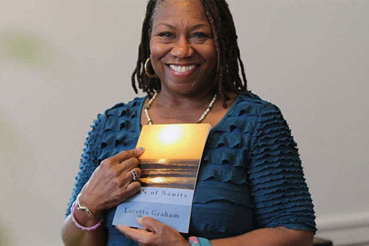 Loretta Graham , who is on the symposium's advisory board, holds a copy of her book, The ABZ's of Sanity. (David Maialetti/Staff Photographer)
