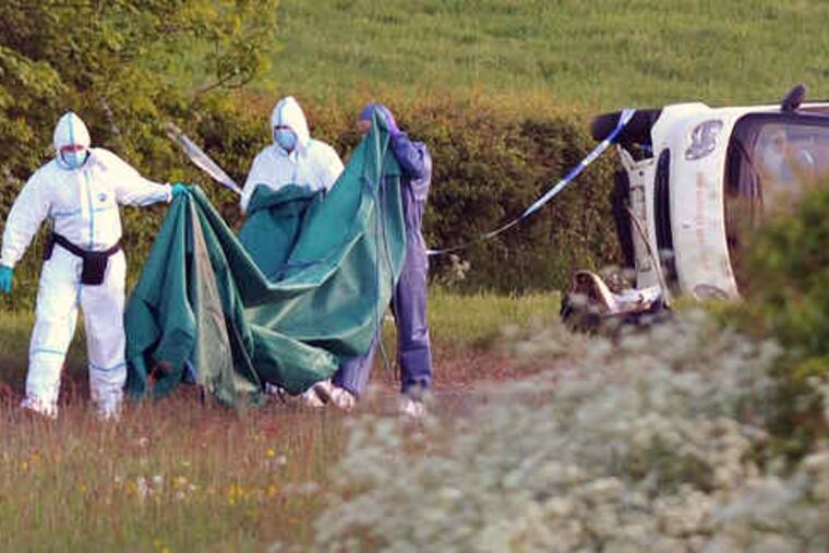 Forensic officers examine a car containing a body near Seascale after Derrick Bird drove through England's scenic Lake District on Wednesday shooting people, killing 12 and wounding 25.