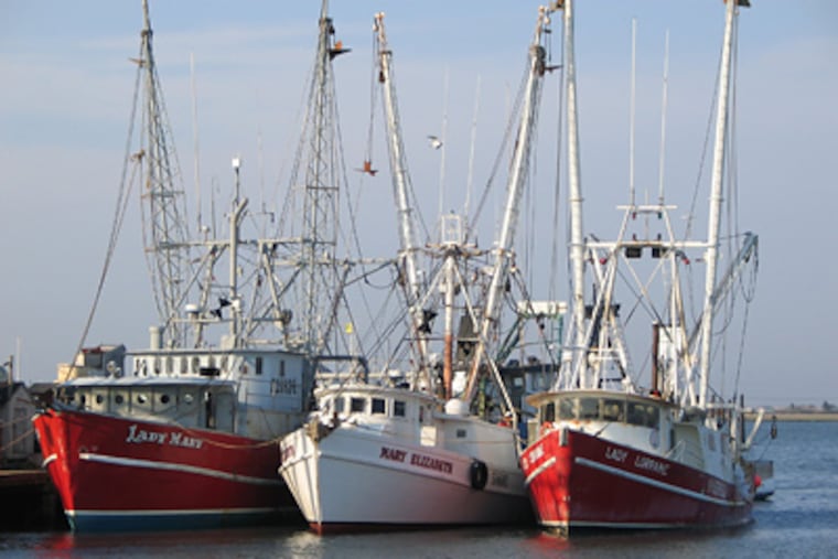 The Lady Mary (left), a 71-foot scallop boat seen here moored in Cape May Harbor, sank at about 5 a.m. on Tuesday march 24, 2009 with seven people aboard about 75 miles off the coast. Only one crew member was conscious and alert when he was plucked with two others from the water by a helicopter. (AP Photo/U.S. Coast Guard, Seaman Daniel Kehlenbach)