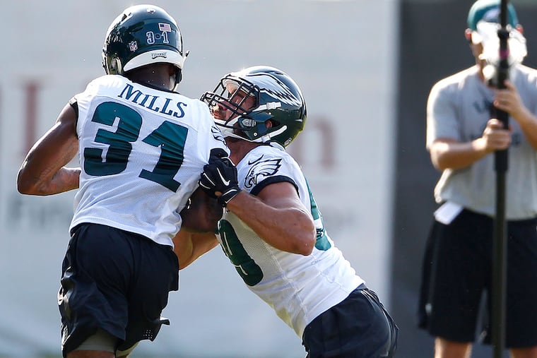 Linebacker Joe Walker (right) goes against safety Jalen Mills during practice.