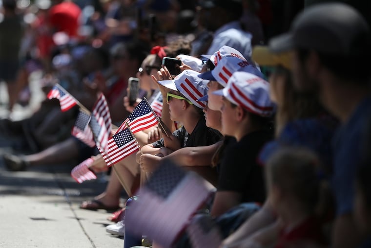 Spectators watch along Market Street during the Salute to America Independence Day Parade in Philadelphia, Pa. on Monday.