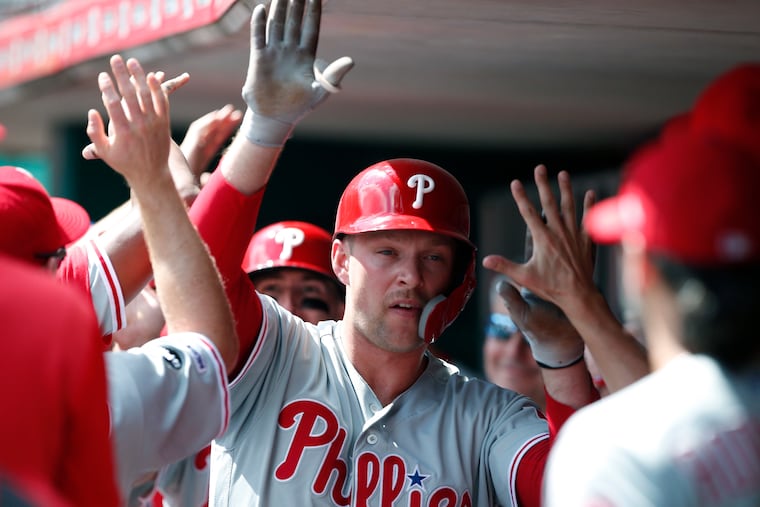 Rhys Hoskins is congratulated in the dugout after hitting a two-run homer in the third inning of Monday's win against Cincinnati.