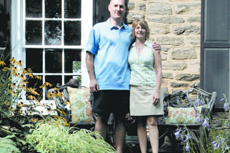 George and Maria Hasenecz, outside their newly renovated carriage house. She is president of Livable Landscapes, a design company. (Bonnie Weller / Staff Photographer)