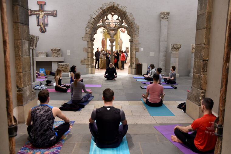 Amid European masterpieces, 1100-1500, at the Philadelphia Museum of Art, yogi Bruno Circolo (center, rear) of Dhyana Yoga leads a class.