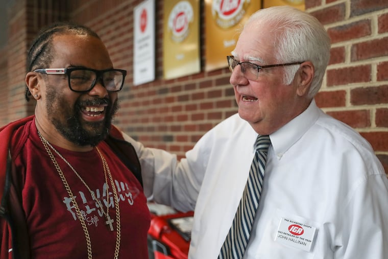 John Hallinan, right, greets Julius Kane, who manages the produce section at night, as he enters for his shift at the Richmond Shops IGA at Fishtown Crossing in Philadelphia on Wednesday, Jan. 4, 2023. Hallinan has been named one of IGA's nine retailers of the year for his Richmond Shops independent grocery store