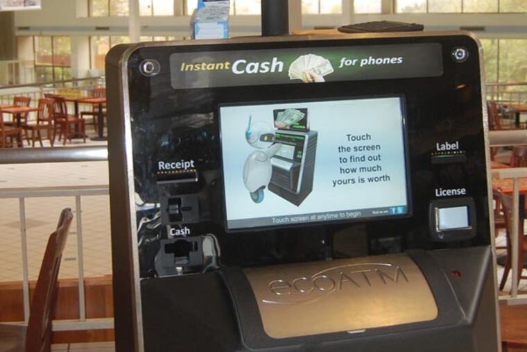 This undated photograph provided by ecoATM, shows the EcoATM, which is a cupboard-sized machine with a big touch screen and a big metal ìmouthî where you can place your old phone or MP3 player. Its analysis complete, it gives you a quote on the spot, based on what a network of hundreds of electronics-recycling companies are willing to pay for it. If you accept, it spits out cash. (AP Photo/ecoATM)
