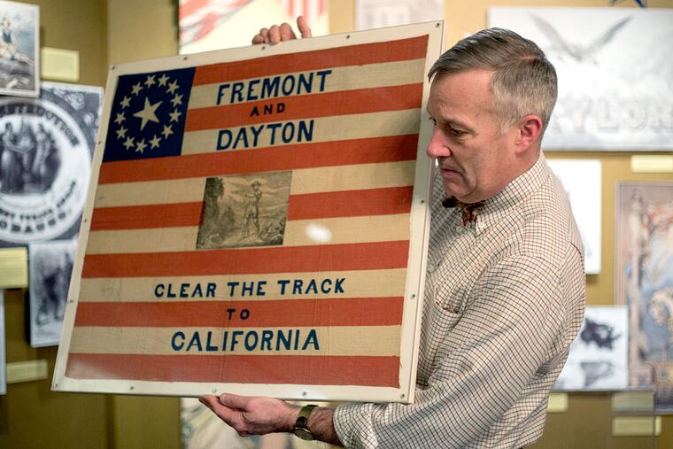 A campaign handkerchief from the 1856 presidential campaign is held by James Mundy, curator of the exhibit "Sweep the Country: Political Conventions in Philadelphia."