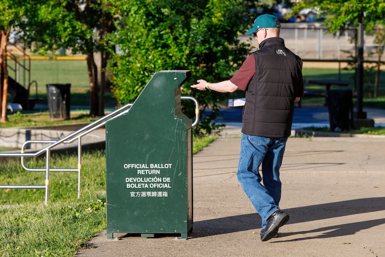 A person places their mail-in ballot into the ballot return box outside the Jimmy O’Connor Playground polling place on Tuesday, May 20, 2025.