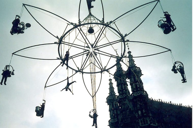 Compagnie Trans Express brings PIFA’s Parisian Street Fair to a close with an aerial performance that features a human carillon dancing, playing music and soaring 200 feet above Broad Street. Credit: Henry Kuhl.