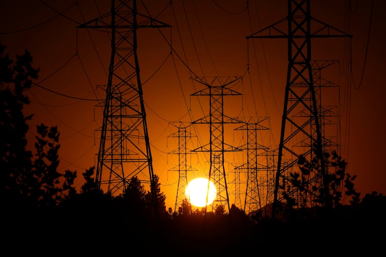 The sun sets behind high-tension power lines on Sept. 23, 2024, in the Porter Ranch section of Los Angeles. Mark J. Terrill / AP