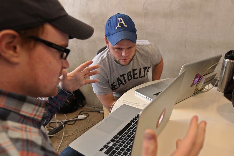 Kyle Fiedler (left) talks with Nat Lownes, his partner in the creation of a program to visualize starting lineups for all Major League Baseball teams using existing databases.