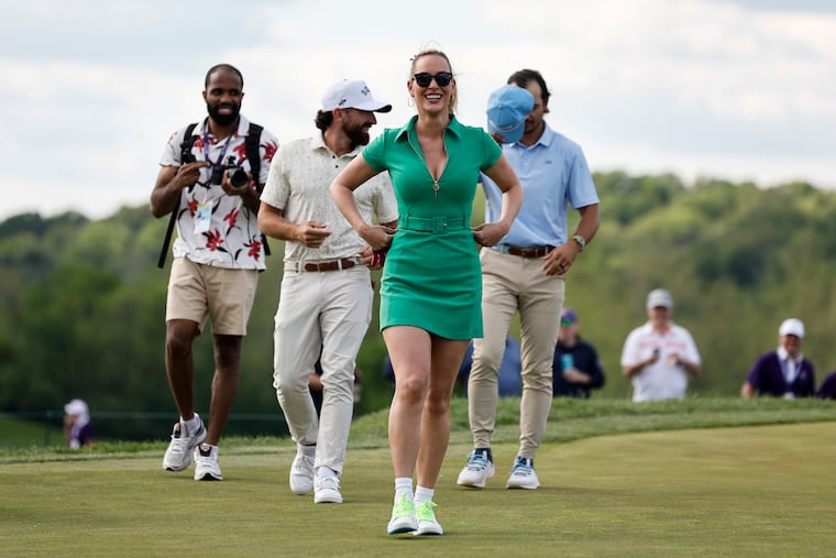 Paige Spiranac, center, walks with her teammates during the Creator Classic event ahead of the Truist Championship at the Philadelphia Cricket Club.