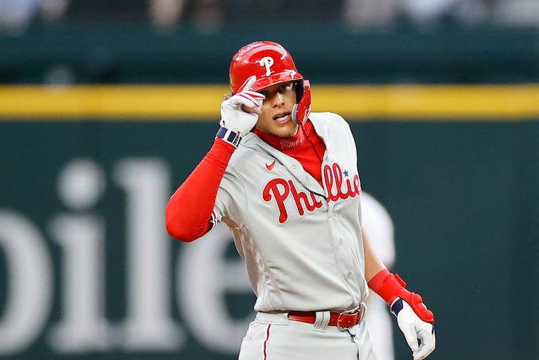 Phillies Alec Bohm tips his helmet after hitting a double against the Texas Rangers at Globe Life Field in Arlington, Texas, on Thursday.