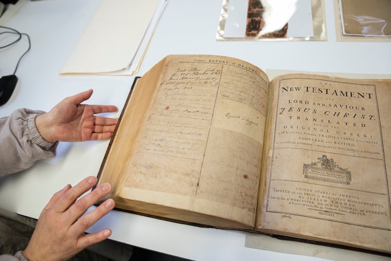 Jungohk Cho, who restored Betsy Ross' family Bible, flips through its pages in the lab at the Conservation Center for Arts and Historic Artifacts in the Rittenhouse neighborhood of Philadelphia.