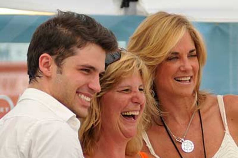 David Gregory,left, and Kassi DePaiva, right, from “One Life to Live," pose for a picture with a happy fan at the Single Best Town in America Block Party Tuesday, Aug. 3, 2010, in Three Lakes, Wis. (AP Photo/Luke Laggis/Rhinelander Daily News)