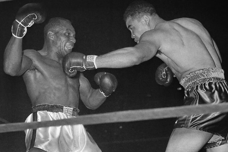 ** FILE ** Heavyweight champion Joe Louis, right, bounces a left off the chin of challenger Jersey Joe Walcott in the fourth round of their scheduled 15-round title fight at Madison Square Garden in New York, in this Dec. 5, 1947 file photo.