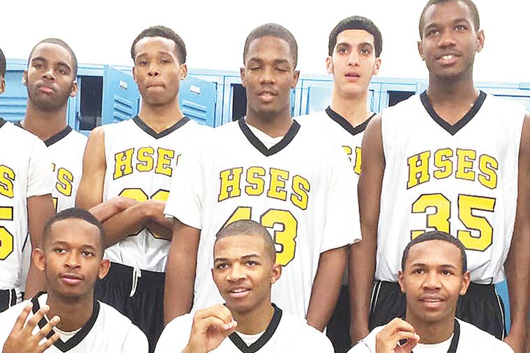 Members of the E&S basketball team celebrate coach's 400th win.