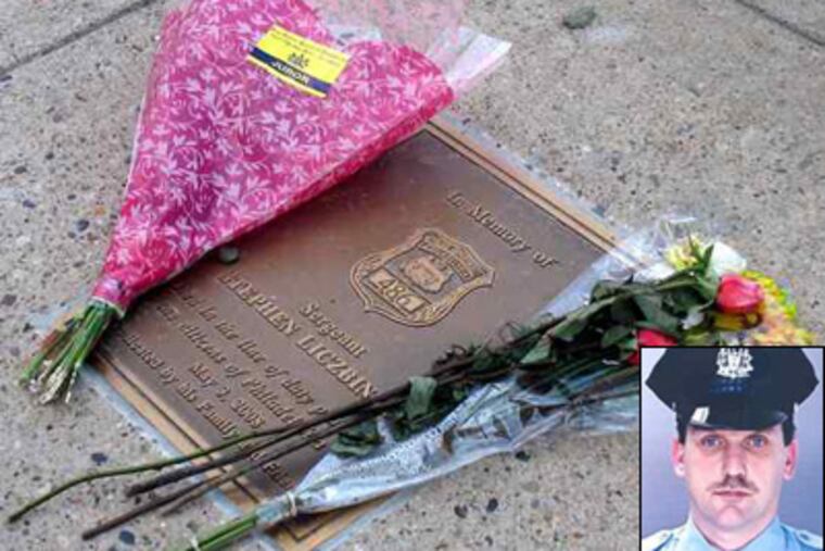 People still leave flowers at the memorial marking the spot where Police Sgt. Stephen Liczbinski (inset) was killed in 2008. (Joseph A. Slobodzian / Staff)