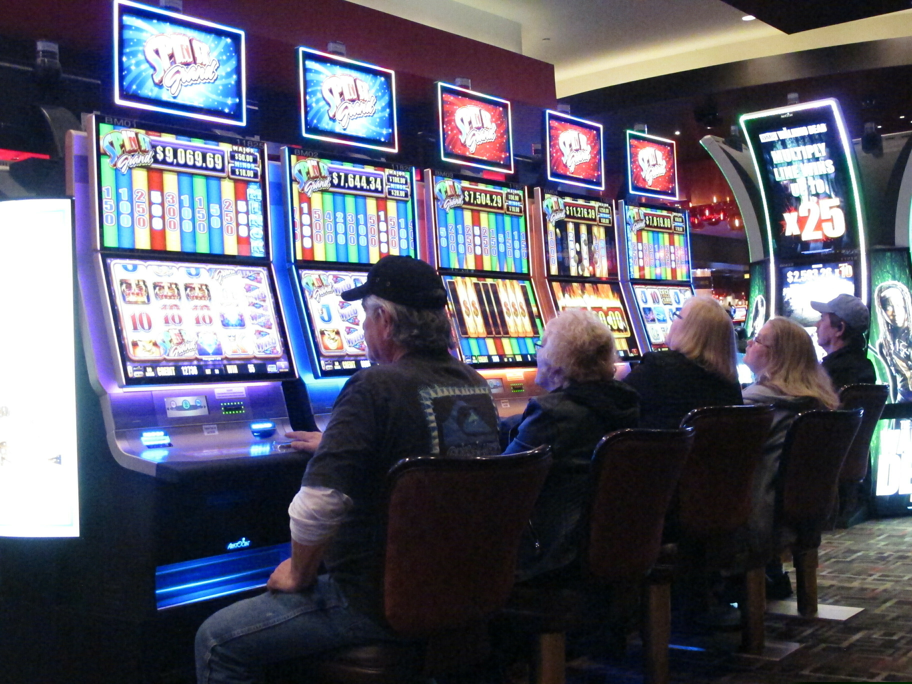 This Feb. 22, 2019 photo shows gamblers playing slot machines in the Golden Nugget casino in Atlantic City N.J. Figures released by New Jersey gambling regulators on May 22, 2019 show that gross operating profit for Atlantic City's nine casinos declined by nearly 30 percent in the first quarter of this year compared to the same period last year, when there were only seven casinos. (AP Photo/Wayne Parry)
