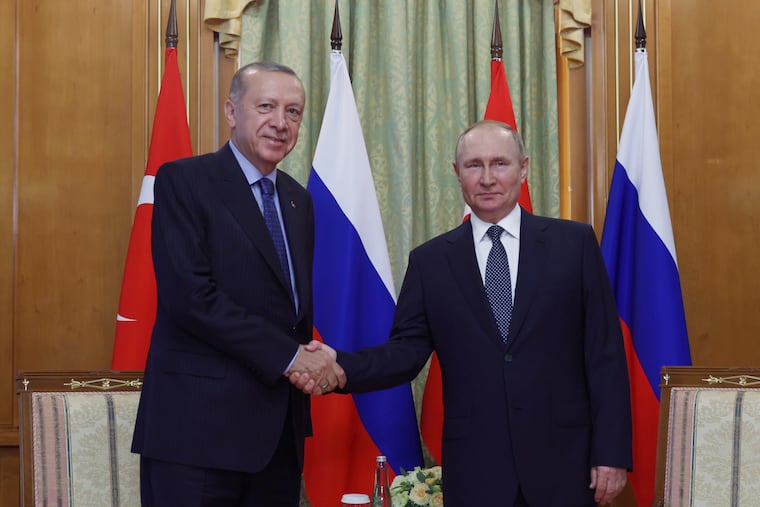 In this handout photo provided by the Turkish Presidency, Turkish President Recep Tayyip Erdogan, left, and Russian President Vladimir Putin shake hands prior to their meeting at the Rus sanatorium in the Black Sea resort of Sochi, Russia, Friday, Aug. 5, 2022.