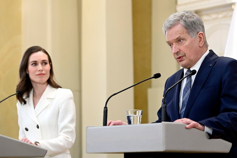 Finland's President Sauli Niinisto and Prime Minister Sanna Marin, left, attend the press conference on Finland's security policy decisions at the Presidential Palace in Helsinki, Finland, Sunday May 15, 2022. Finland’s president and government have announced that the Nordic country intends to apply for membership in NATO, paving the way for the 30-member Western military alliance to expand amid Russia’s war in Ukraine. (Heikki Saukkomaa/Lehtiuva via AP)