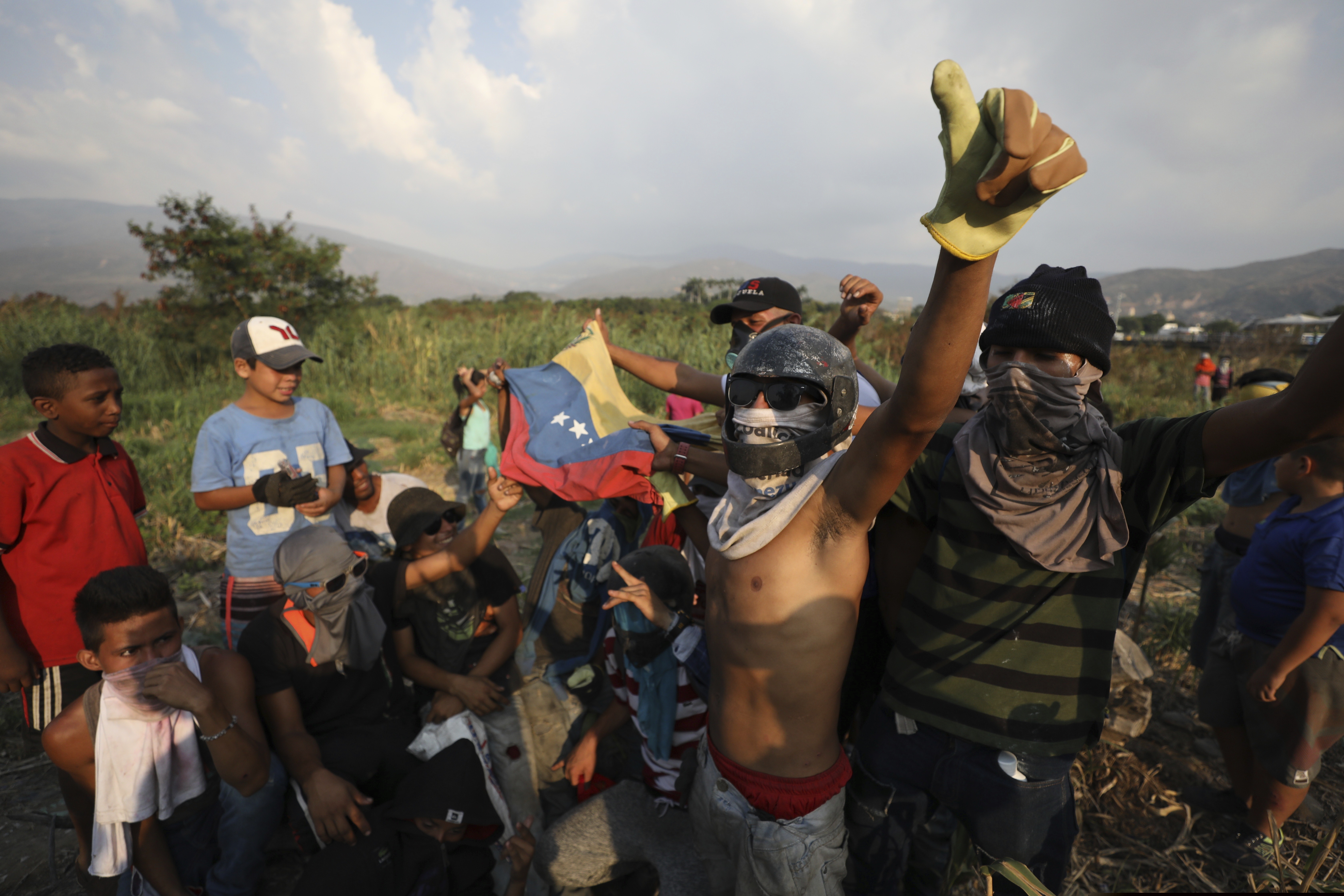 Venezuelan migrants near the Simon Bolivar International Bridge plead for people to support them with food and water so they can continue protesting in La Parada near Cucuta, Colombia, on Sunday.