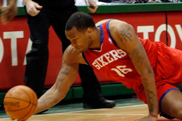 Marreese Speights dives for a loose ball against the Milwaukee Bucks. The Sixers lost to the Bucks, 91-88. (AP Photo/Darren Hauck)