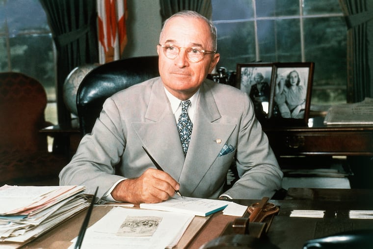 President Harry Truman poses at his White House office desk in 1948 in Washington. That year, most Black voters stuck with Truman, despite the allure of Progressive Party candidate Henry Wallace.