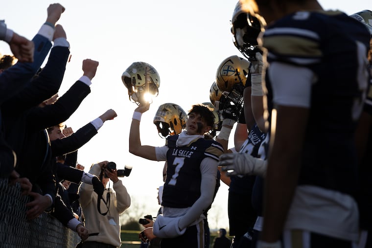 Explorers quarterback Gavin Sidwar (7) celebrates with teammates and fans after winning the PIAA Class 6A football semifinal game between La Salle College High and North Penn on Nov. 29.