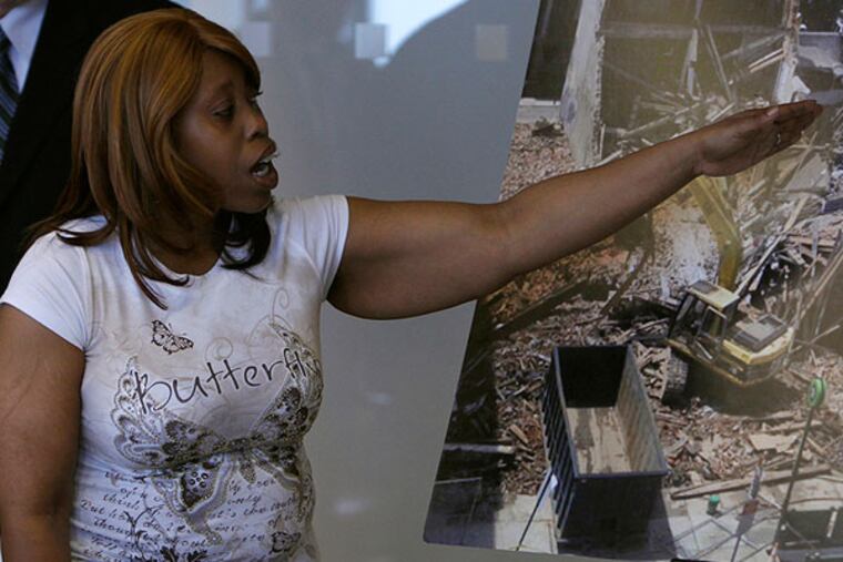 Felicia Hill points to a photo of the Salvation Army building, when telling her story of how she escapedfrom Wednesday's building collapse. Hill was working in the Salvation Army thirft shop at the time of the collapse, and was pulled from the building by a bystander. June 10, 2013. (LUKE RAFFERTY/Staff Photographer)