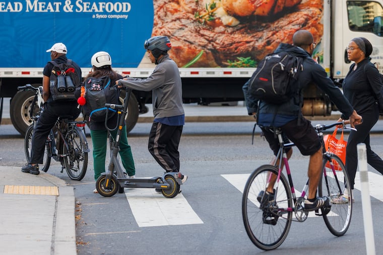 At 15th and Market Streets, electric bikes, electric scooters, traditional bicycle and pedestrians converge.