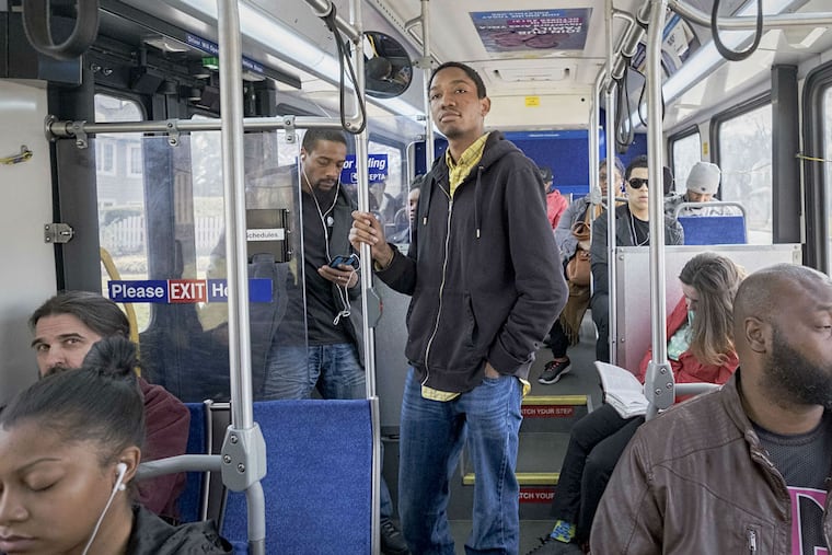 Nate Baird, 21, prepares to get off SEPTA's Route 125 bus. Fellow riders include Zoe Tanner (second from right) and Carl Burch (right).