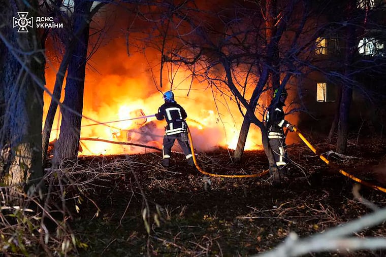 Firefighters work after a Russian rocket attack that hit a multi-story apartment building in Sumy, Ukraine, on Sunday.