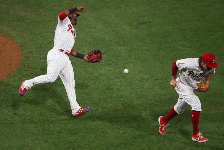 Jean Segura (left) fails to make the catch off the Pedro Severino pop up in the ninth inning of a game against the Baltimore Orioles at Citizens Bank Park in Philadelphia on Tuesday, Aug. 11, 2020. Orioles won the game in the 10th inning, 10-9.