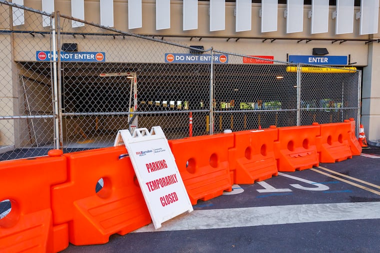 Fencing and signage blocks drivers from a new parking garage at Community Medical Center in Toms River, NJ. Township officials closed it temporarily due to a structural deficiency.